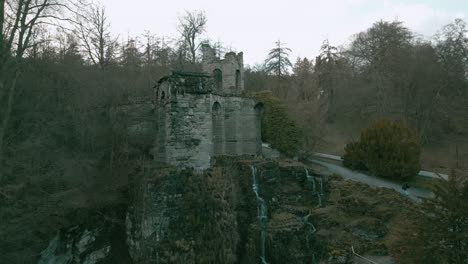 aerial delight: amazing drone footage of waterfall and ancient ruin in berpark wilhelmshöhe, kassel