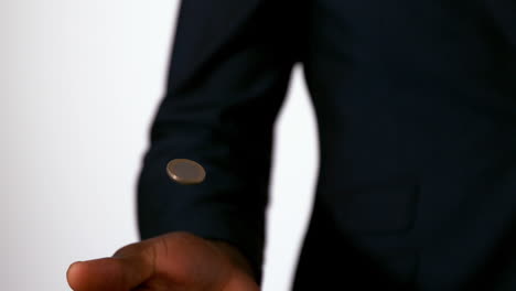 businessman catching falling coin in hand