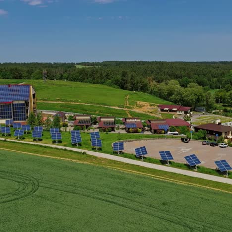 modern complex with photovoltaic cells. row of solar panels along the road in nature landscape. sustainable energy. aerial view.