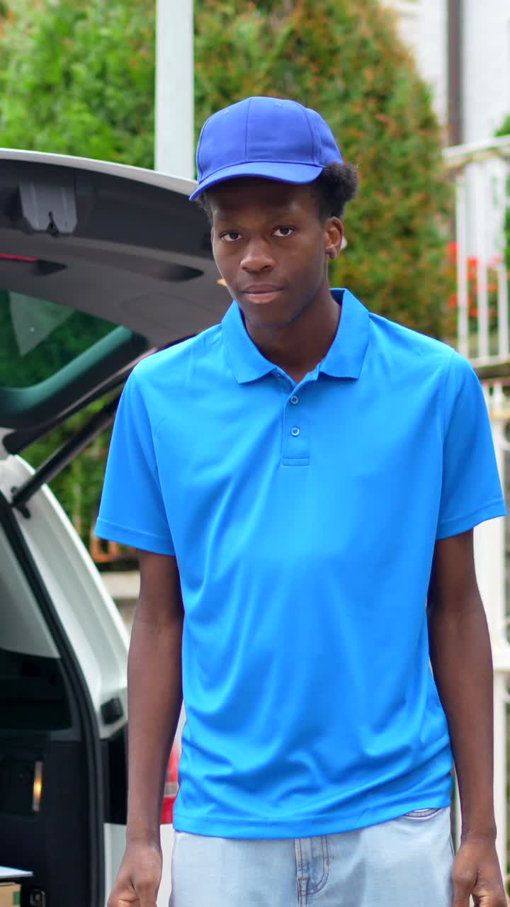 Delivery person standing in front of car with open trunk