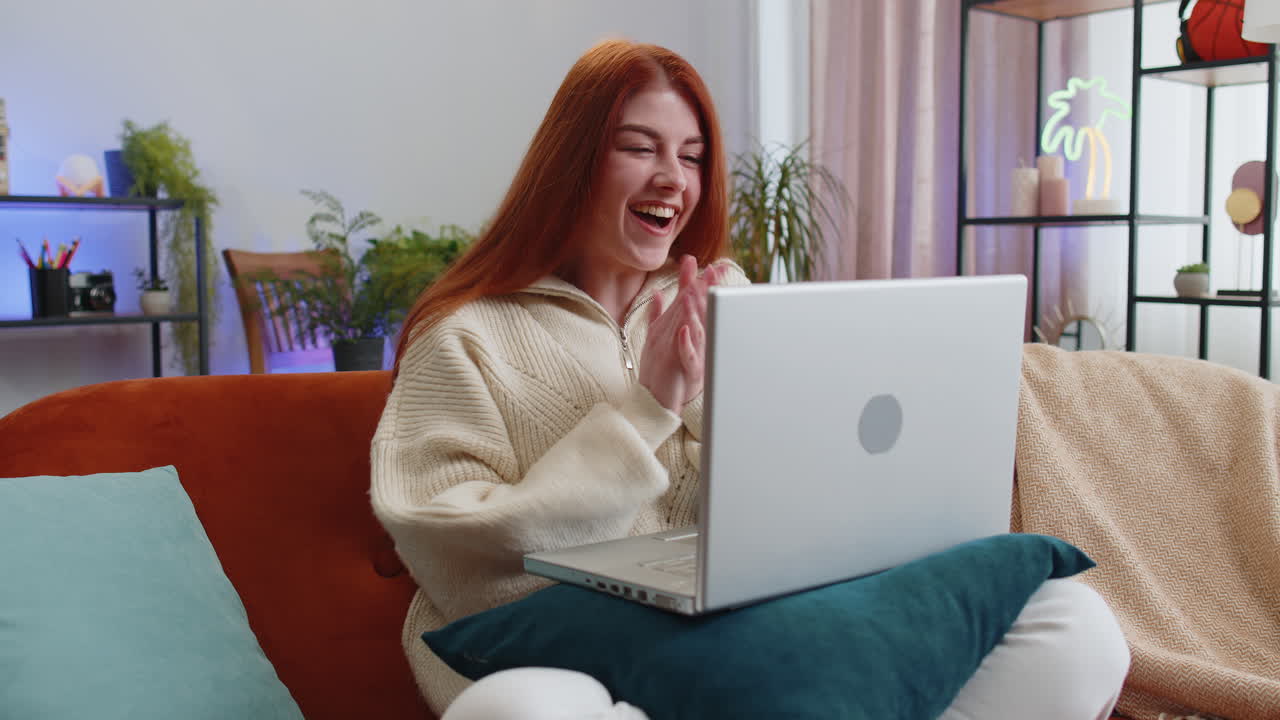 Amazed young woman use laptop computer receive good news message shocked by victory celebrate win