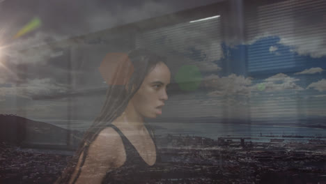 compuesto de mujer de raza mixta con dreadlocks corriendo, y paisaje costero con cielo azul nublado