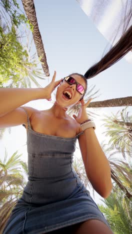 dynamic portraits of a young woman under palm trees