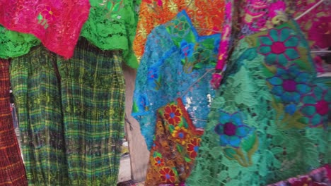 pan across colorful lace clothing in central american street market