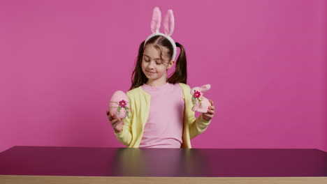 small cheerful girl showing colorful decorated ornaments on camera