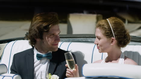 just married couple in a blue convertible car