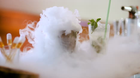 dry ice in glass while bartender preparing drink