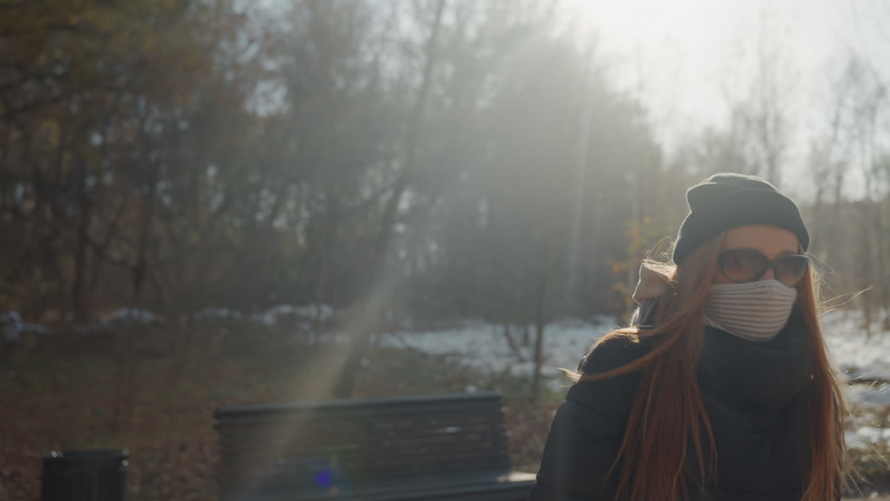 Quiet lady walks gently across icy surface. Serene woman advances smoothly over frozen terrain at night. Calm woman moves silently across icy landscape beneath darkening evening sky