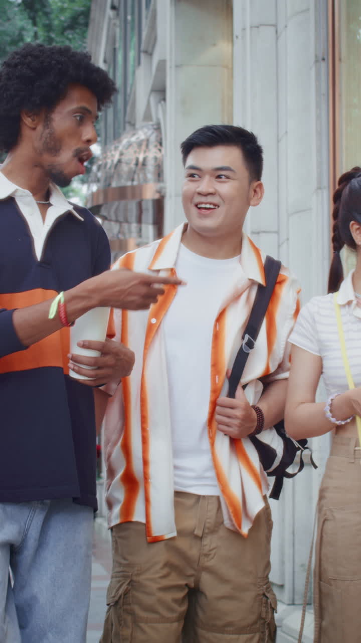 Men and Their Female Friend Walking and Chatting in City Center