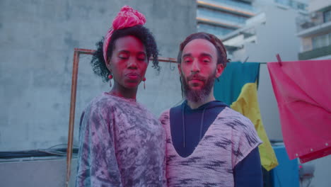 Portrait of Beautiful Couple of Dancers in Neon Light on Urban Rooftop