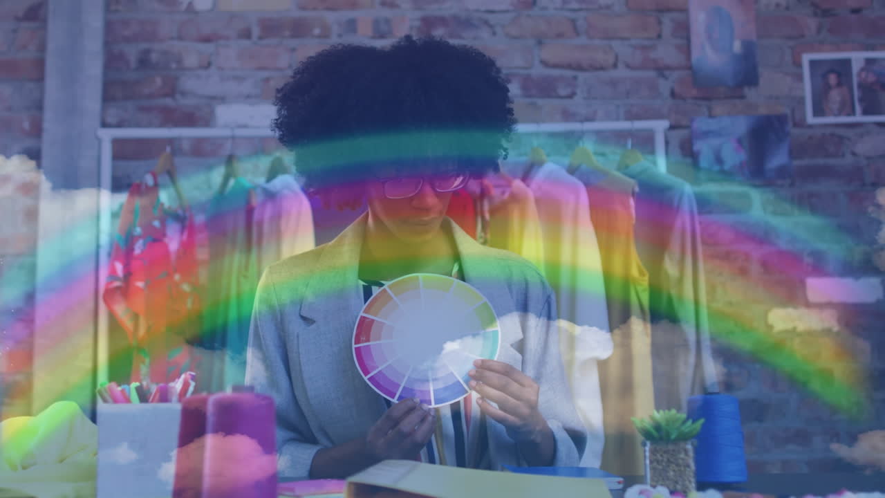 Video of rainbow over biracial female designer
