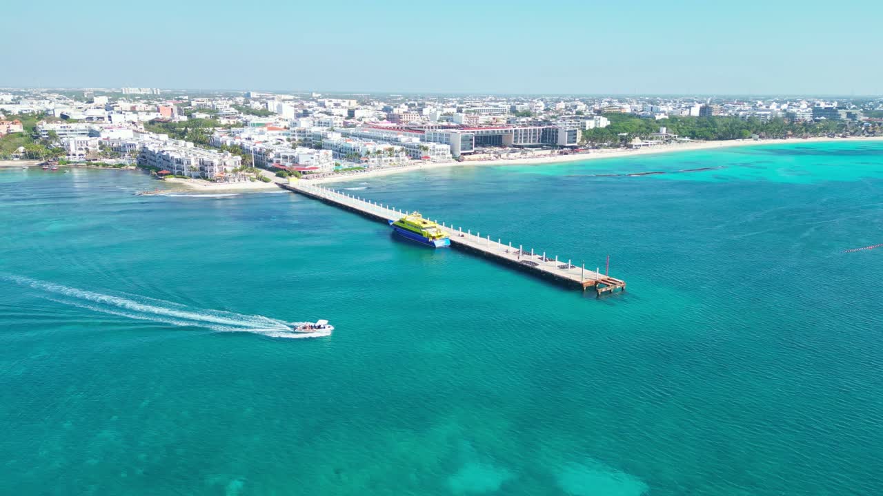 Playa del carmen, mexico, with clear turquoise water and a pier, aerial view