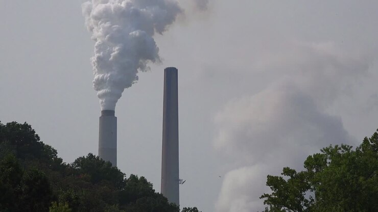 Smokestacks belch pollution into the atmosphere releasing greenhouse gas and contributing to global warming
