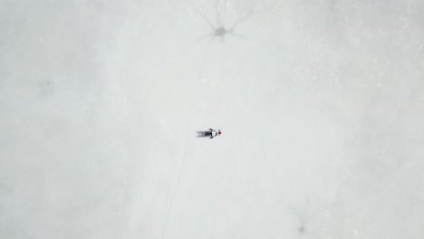 Aerial-footage-girl-layed-down-on-ice