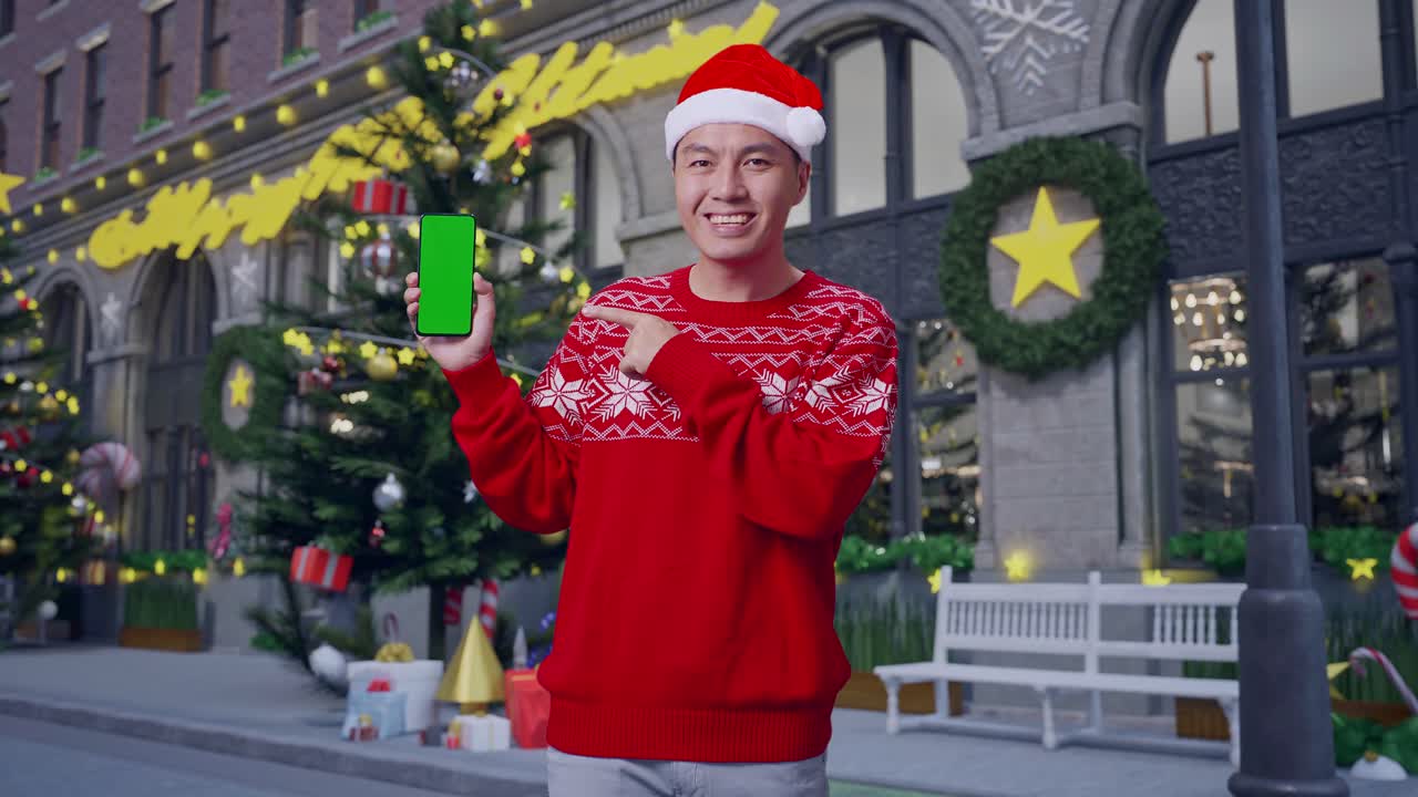 녹색 화면 을 가진 전화 를 들고 있는 산타 모자 를 입은 남자