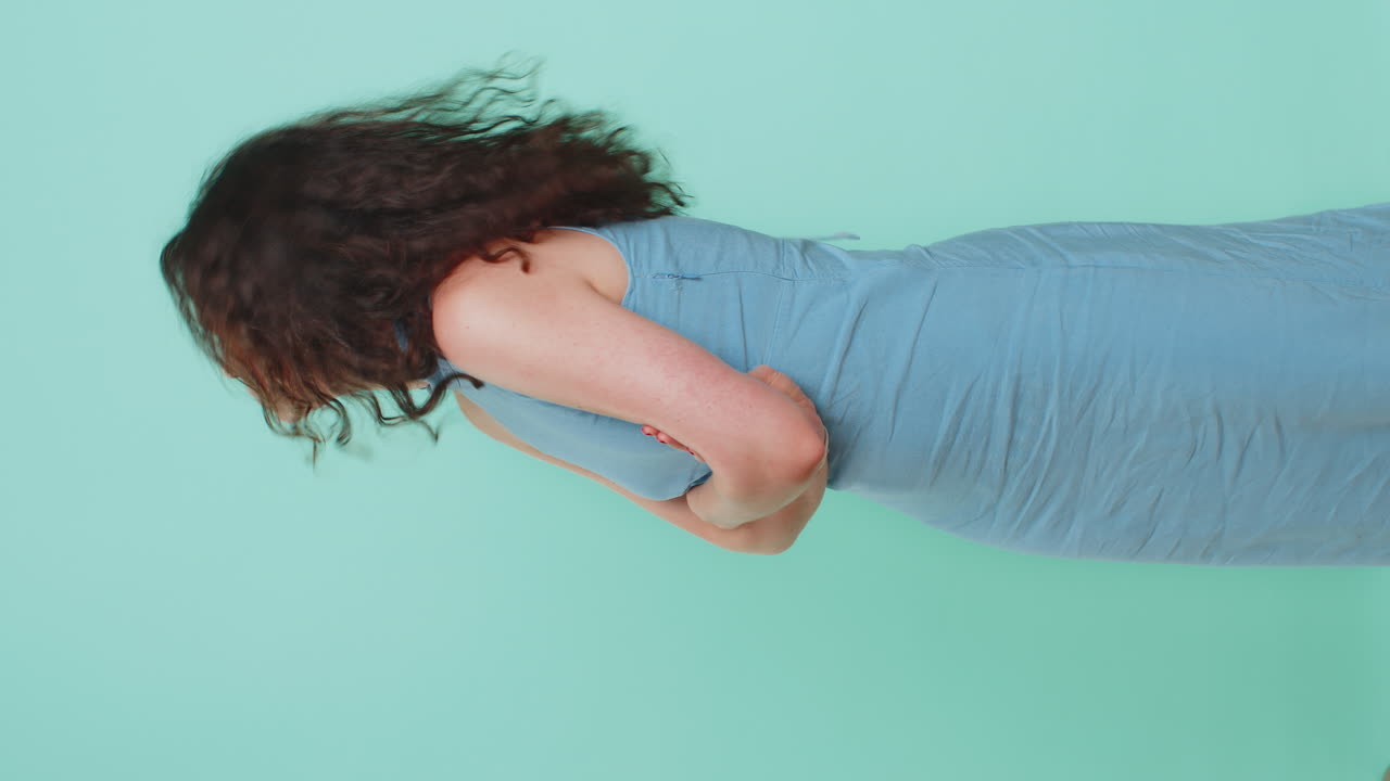 Cheerful funny bully young woman showing tongue making silly faces fooling around joking teasing