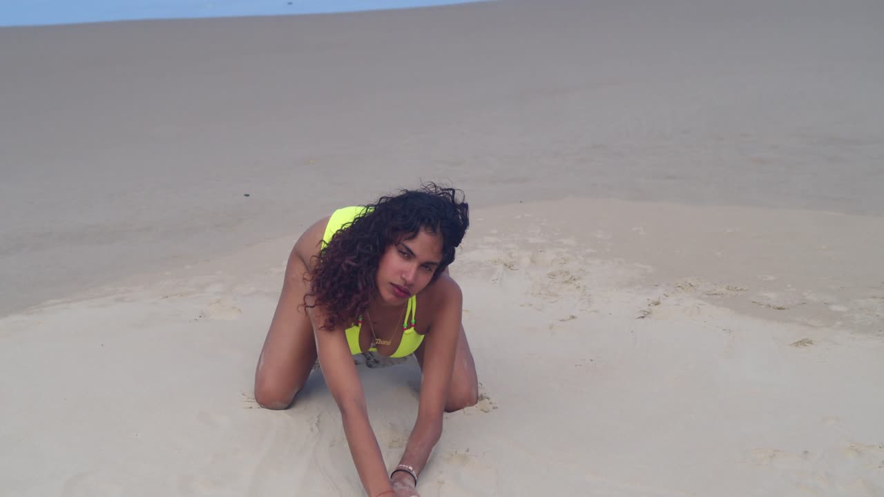 A tropical paradise scene: a young woman in bright yellow swimwear enjoying the Caribbean sun and sand