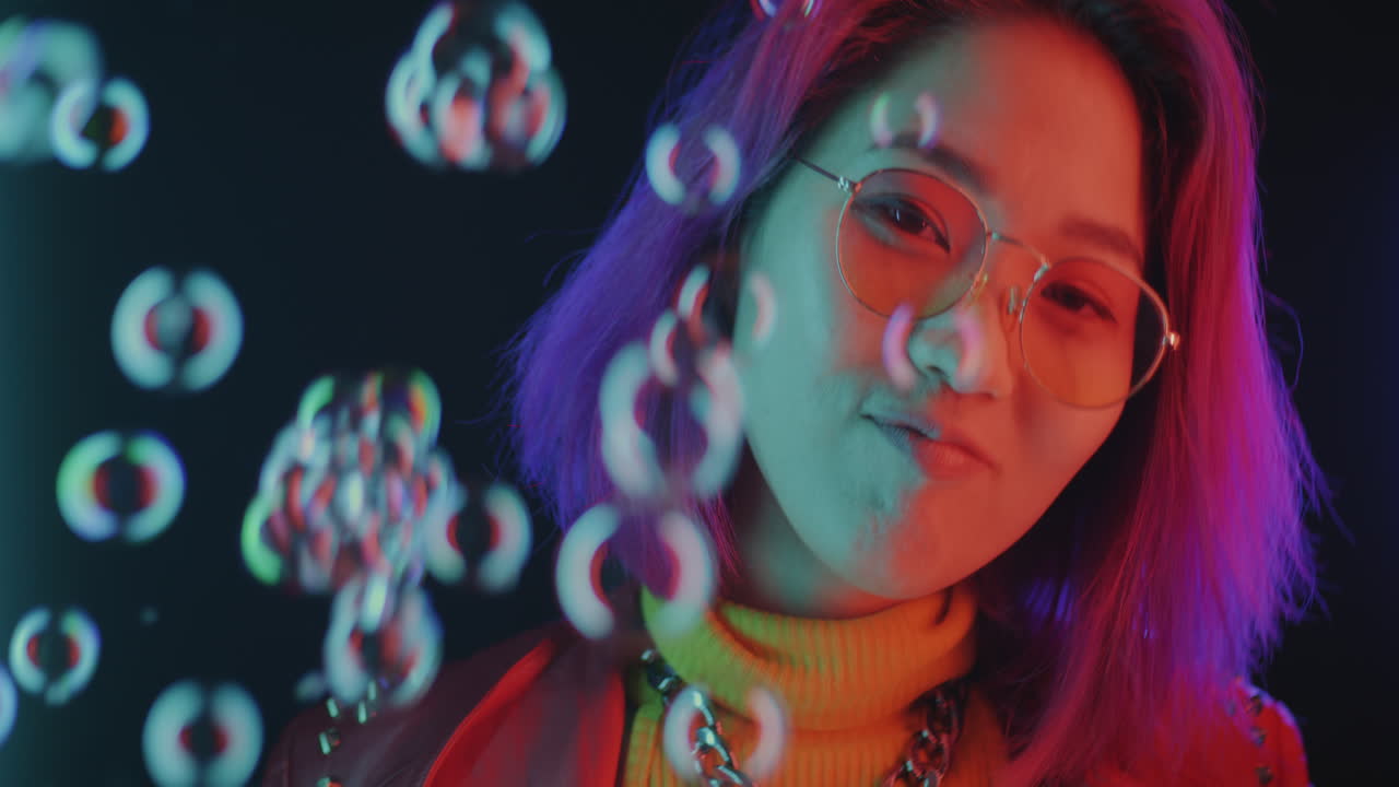 Stylish Young Woman with Purple Hair in Neon Lights