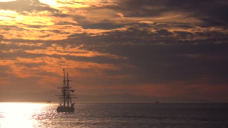 a tall clipper ship sails at sunset 1