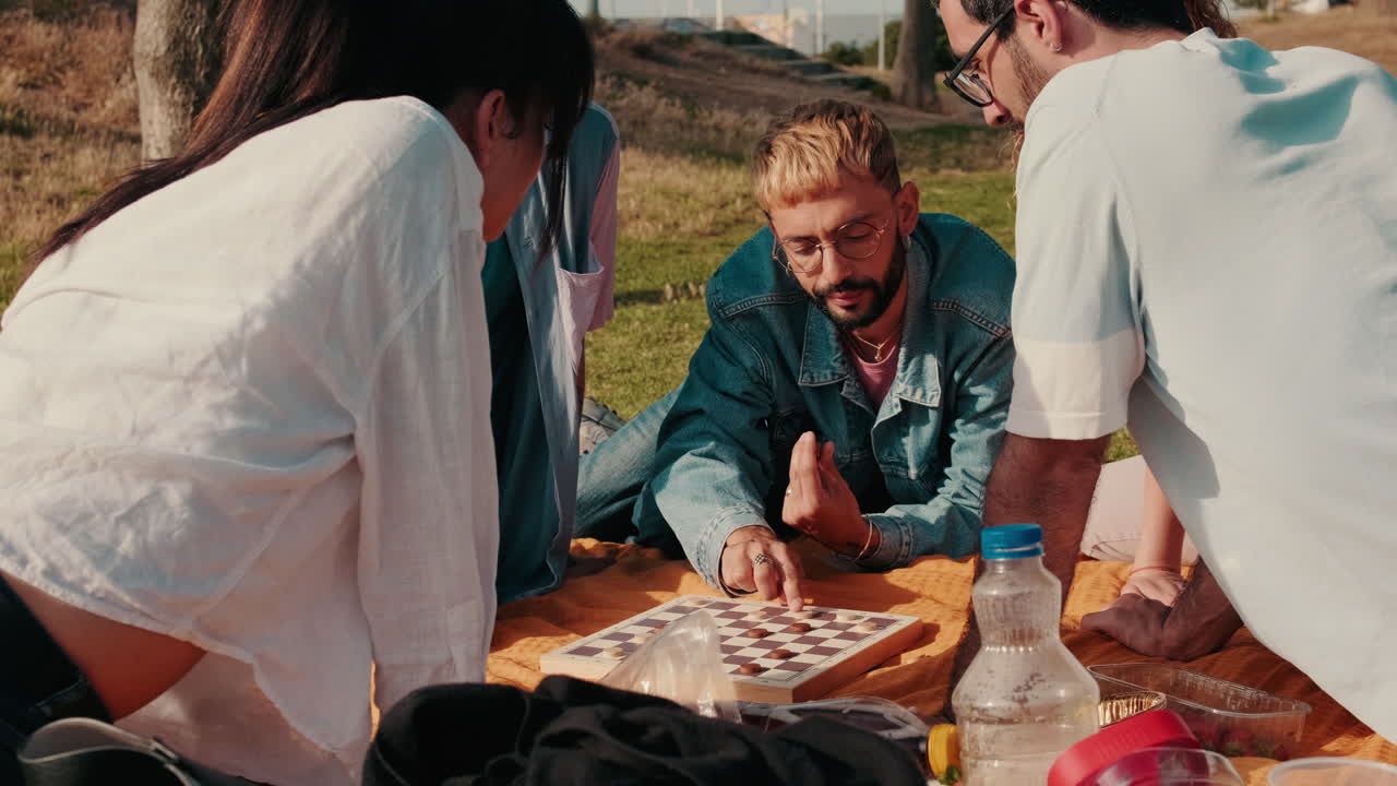 Friends Playing Checkers at a Picnic