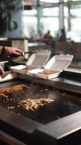 chef preparing and serving food on a hot plate