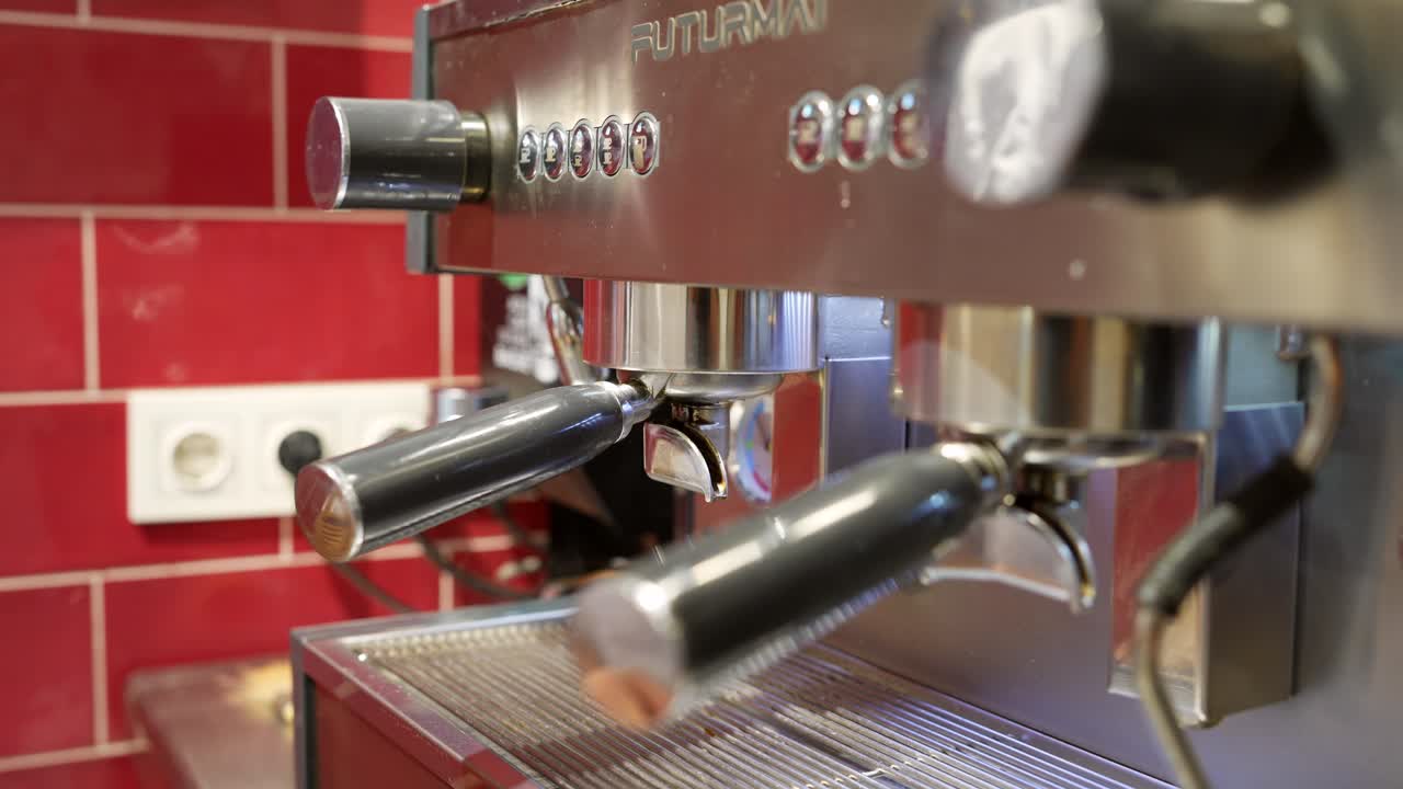 Barista's Hands Inserting Portafilter into Professional Espresso Machine