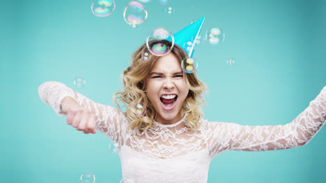 crazy face woman dancing in bubble shower slow motion photo booth blue background