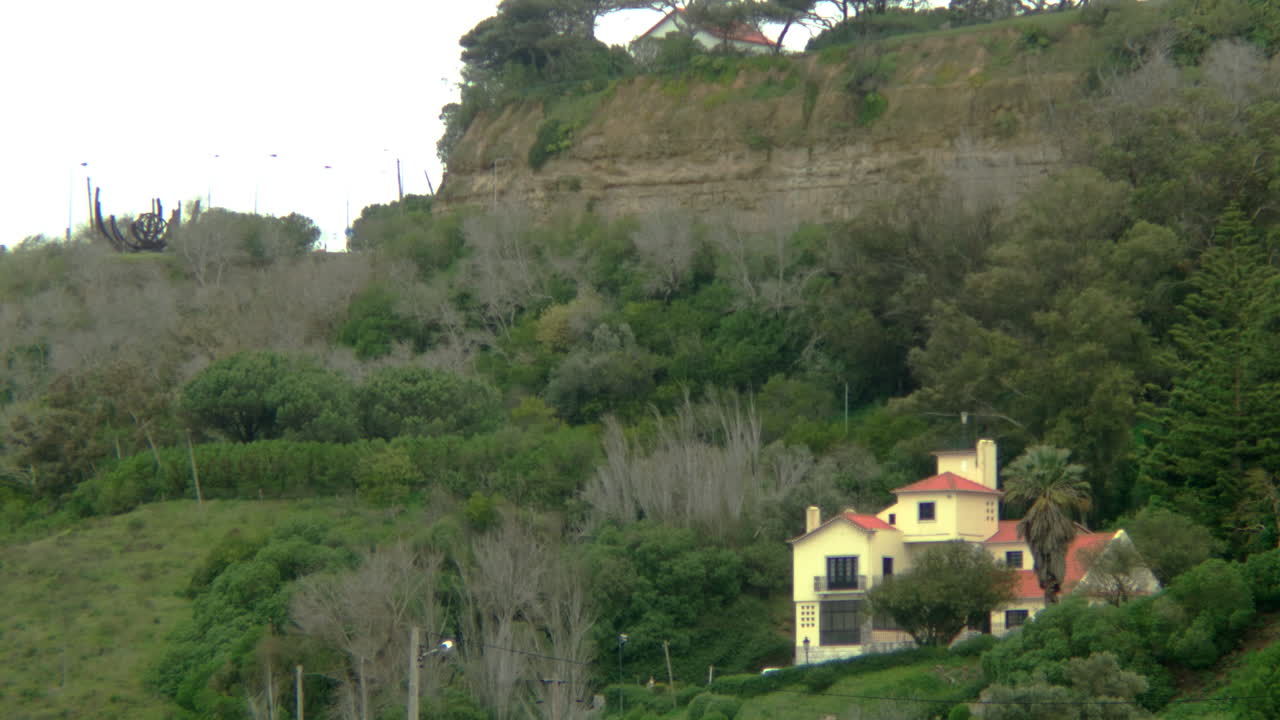 A yellow house by the cliffs.