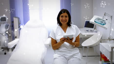 animation of molecules over smiling biracial female doctor in hospital