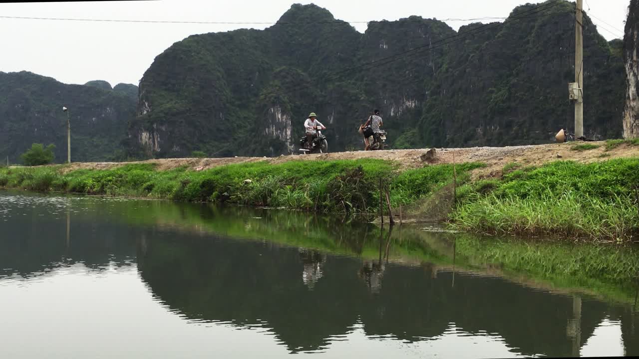 Motocycle crossing along a river in Vietnam