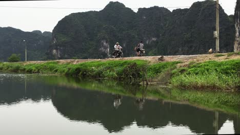 motocycle crossing along a river in vietnam