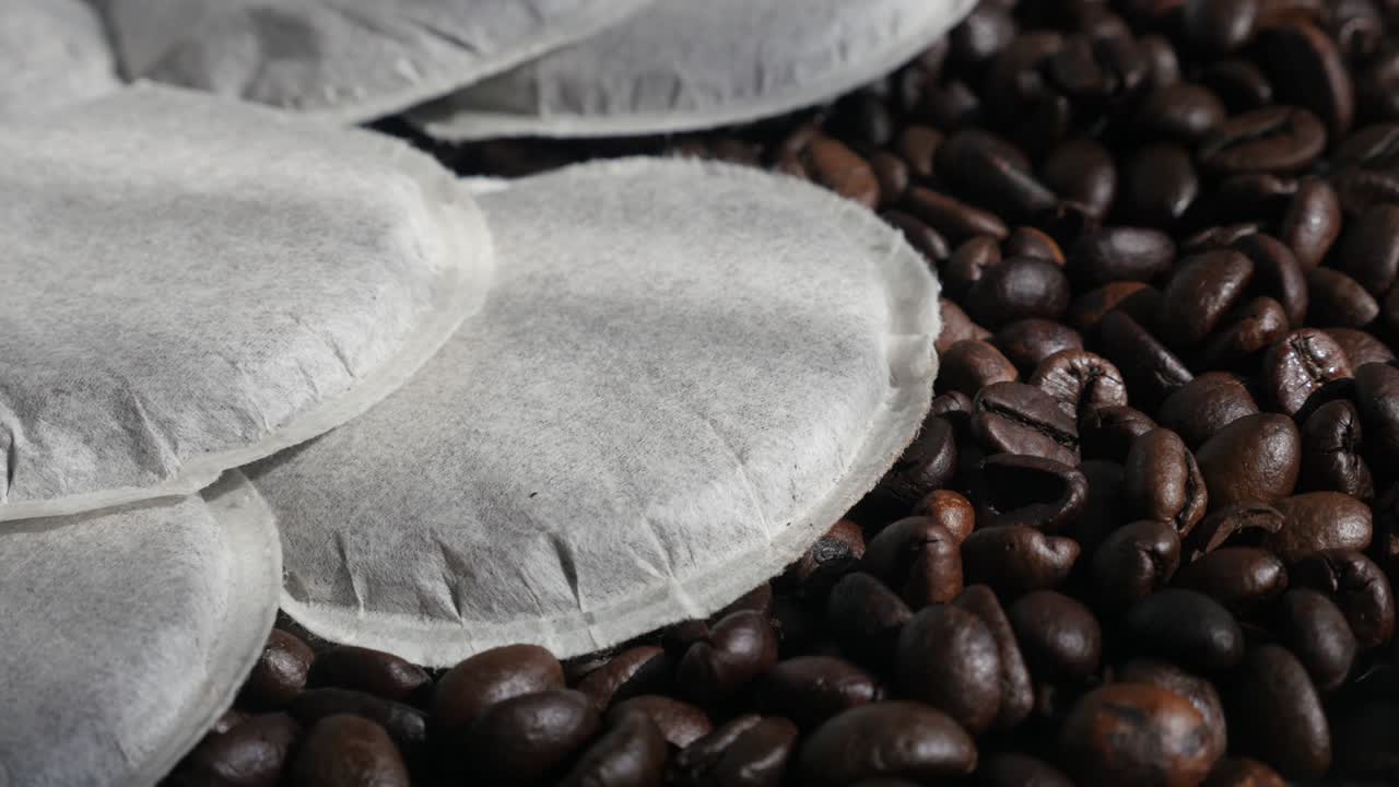 Pile of filter coffee pods and roasted  beans 4K video
