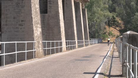 Bicyclist-exercising-on-a-bridge-on-a-sunny-day