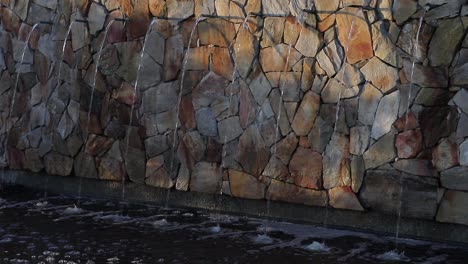 understated urban rock wall fountain has calming geometric symmetry