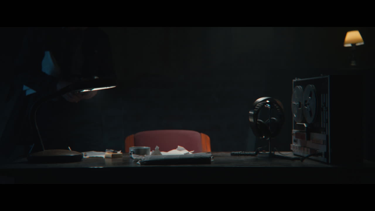 An intelligence officer sits down to the wiretap station