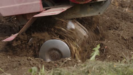 Motor-cultivation-machine-plowing-land-in-private-garden,-close-up