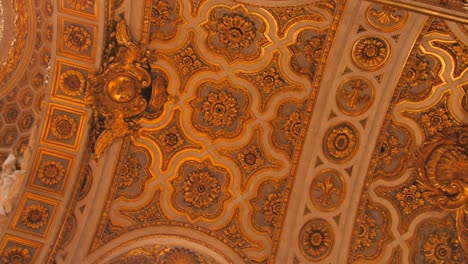 Low-angle-shot-of-interior-golden-colored-design-along-the-ceiling-of-church-of-Saint-Louis-of-the-french-in-Rome,-Italy