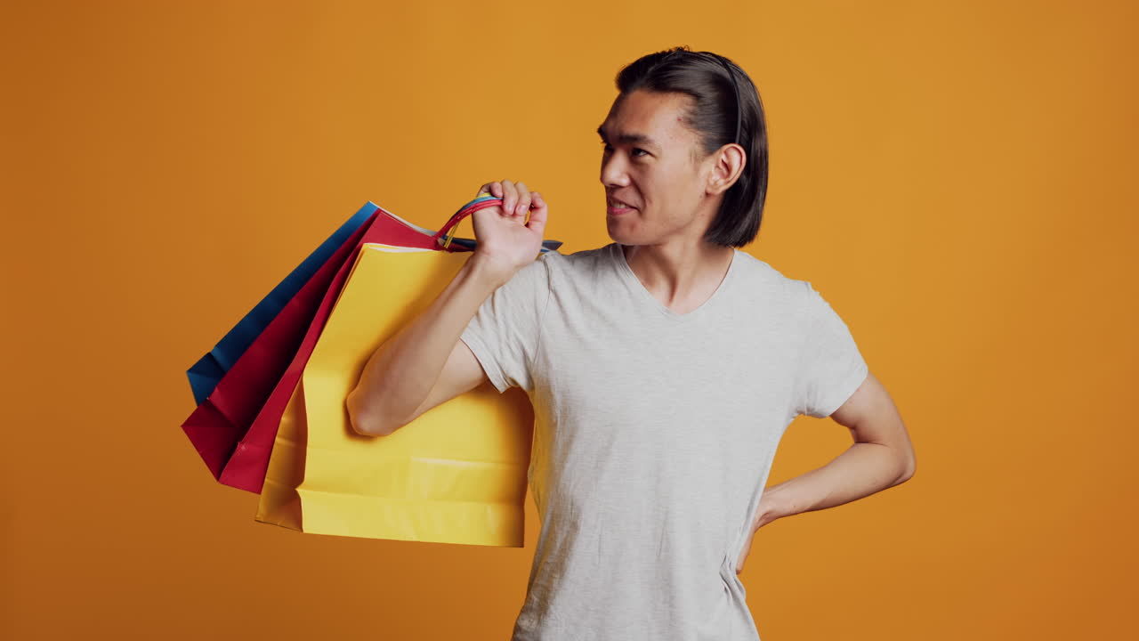 Asian cool man holding shopping bags