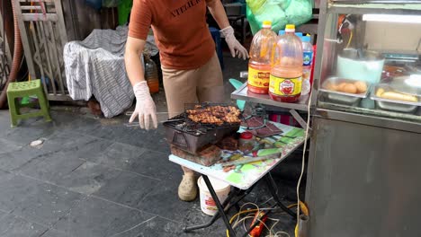 vendor grilling banh mi on hanoi street