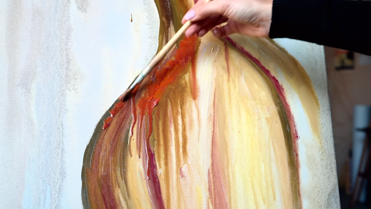 Close up of a woman painting on a canvas at an art gallery workshop