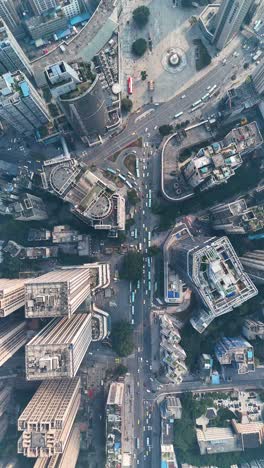 vertical aerial view of busy traffic in chongqing, china, with multiple roads intersecting at a central point. a snapshot of the city’s bustling urban environment and complex infrastructure.