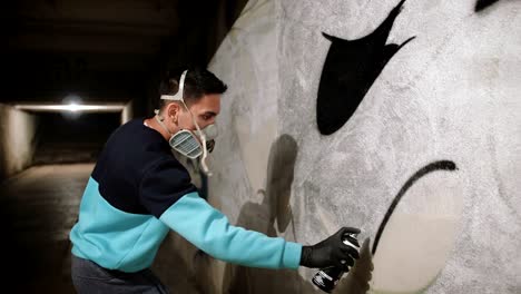 graffiti artist painting on the wall in subway