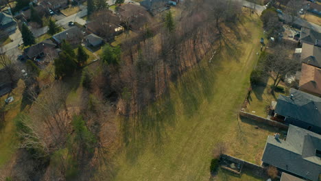 Aerial-drone-view-of-a-neighbourhood-park-surrounded-by-homes