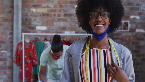 happy african american female fashion designer looking at camera and smiling