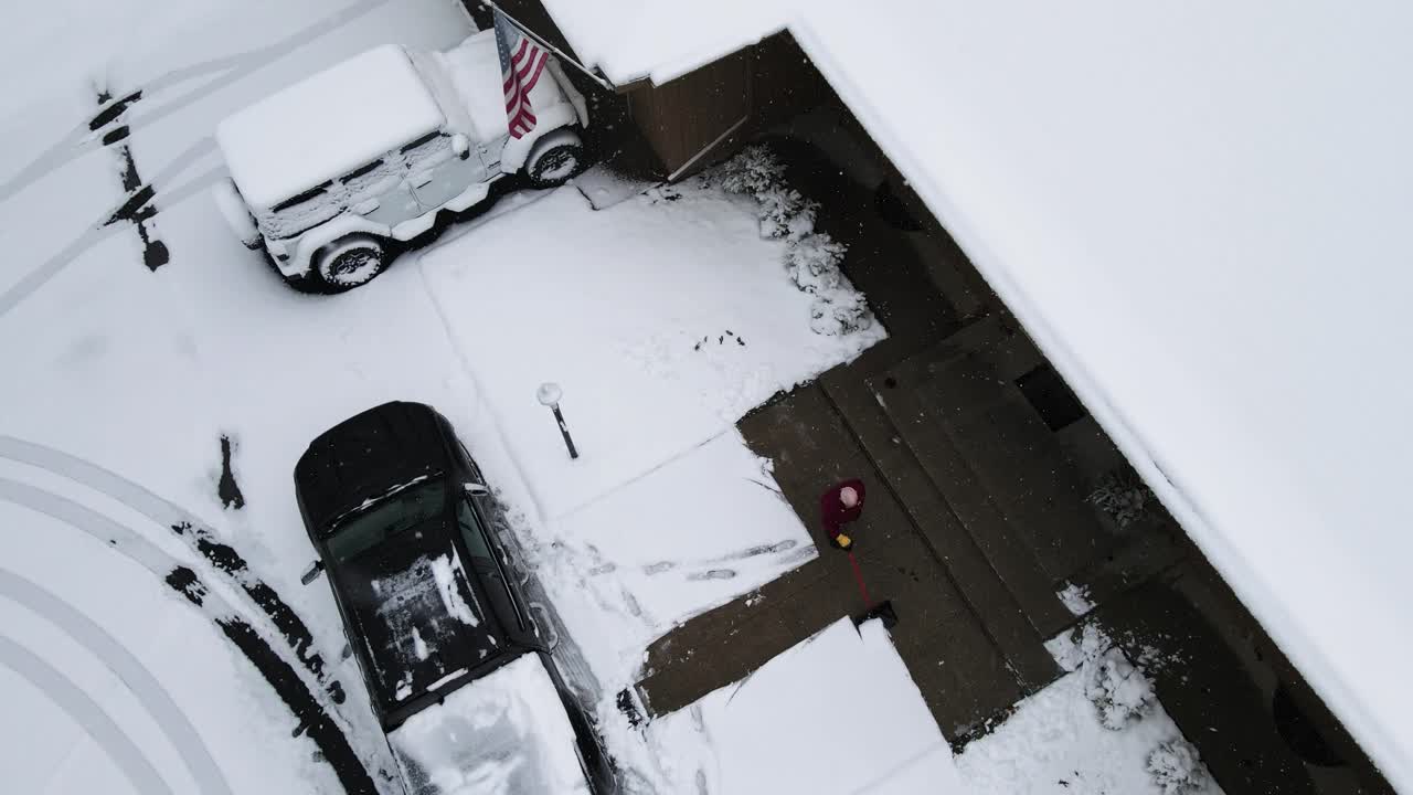 Shoveling a light layer of snow off of a driveway