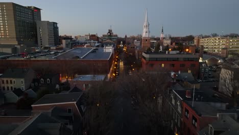 aerial dolly forward over city street during blue hour at night