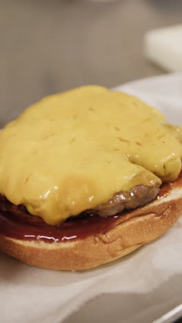 chef putting meat in the burger during preparation in the kitchen