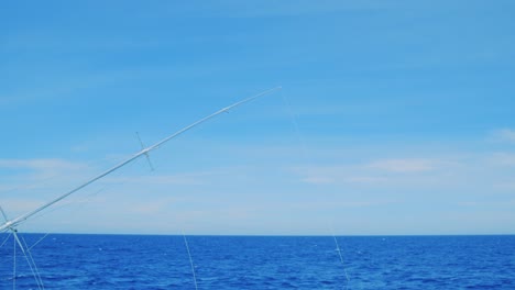 fishing outrigger deep sea trolling, curacao, caribbean, with blue sky and ocean