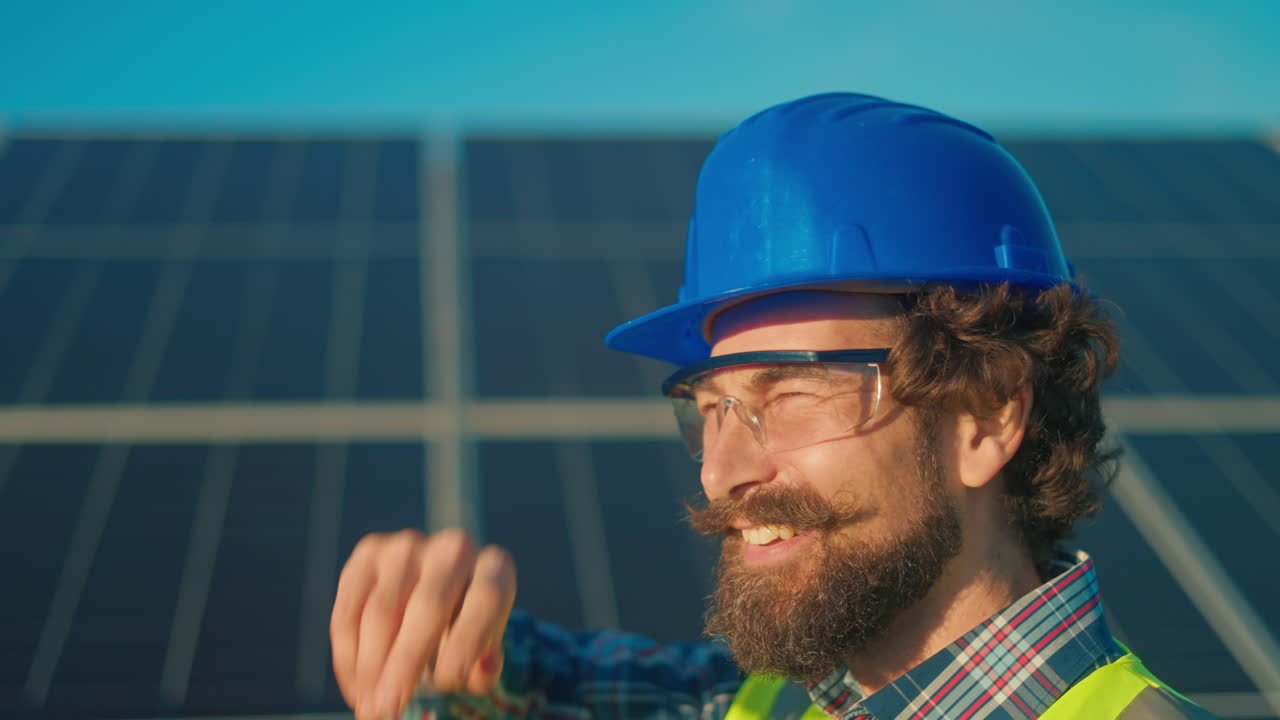 Worker inspecting solar panels