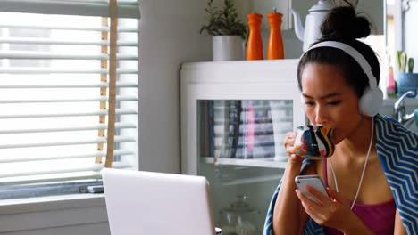 Hermosa-Mujer-Tomando-Café-Mientras-Usa-El-Teléfono-Móvil